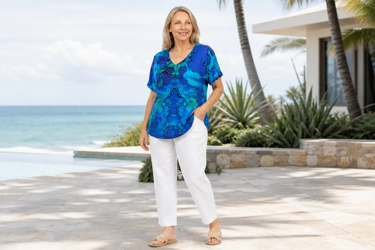 Mature plus-size model wearing the Claire Powell Reef V-neck T-Shirt at a coastal resort