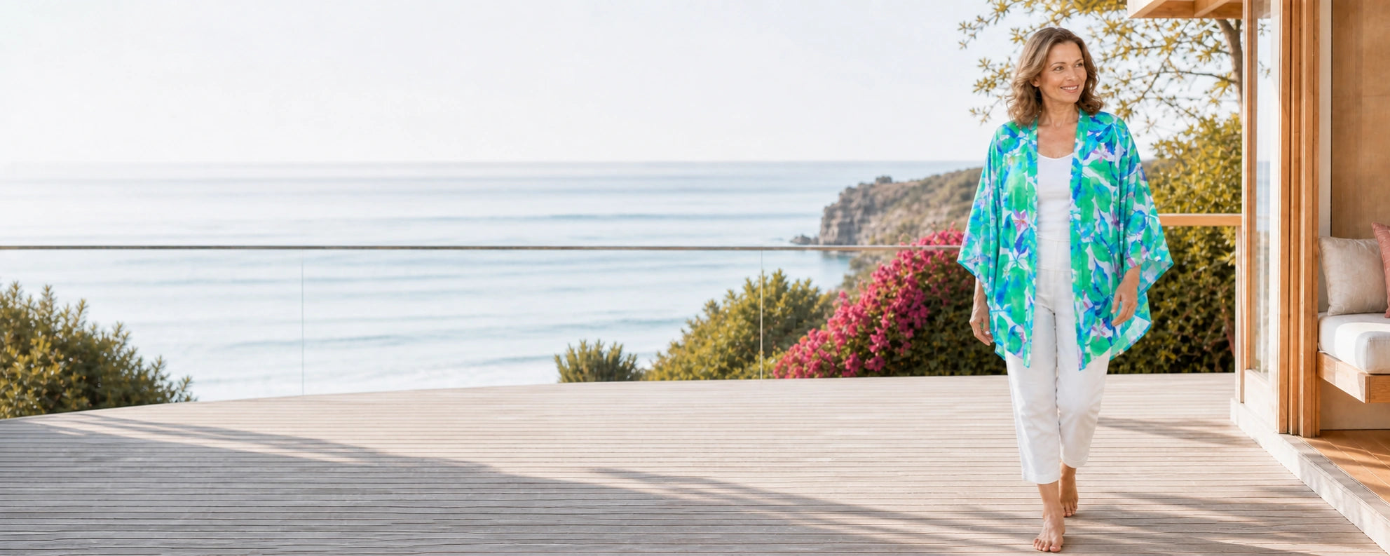 Mature model wearing the Claire Powell Broome modal kimono at a coastal resort