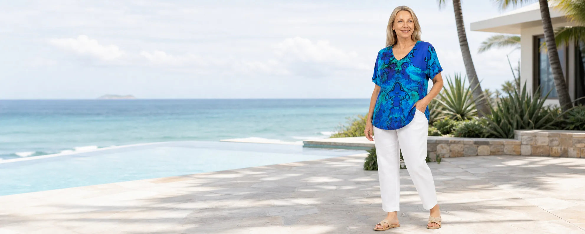 Mature plus-size model wearing the Claire Powell Reef V-neck T-Shirt at a coastal resort