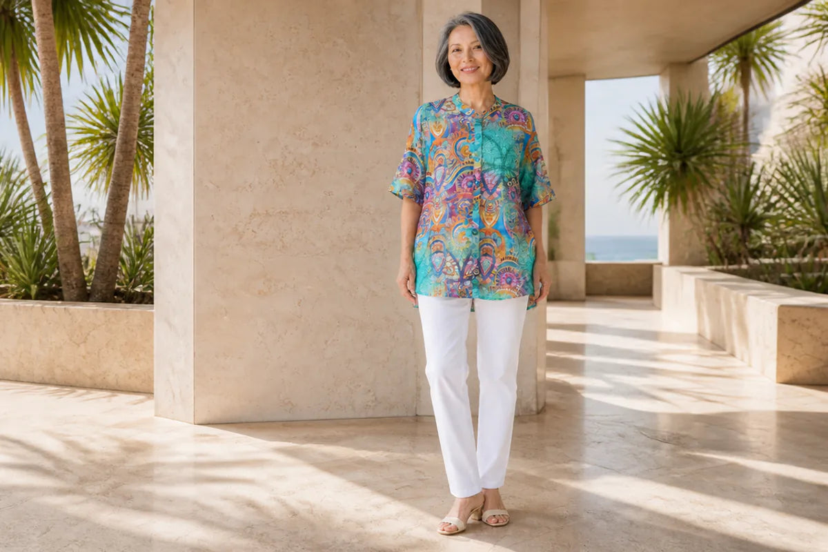 Mature model wearing a Claire Powell Mosaic A-line shirt at a coastal resort