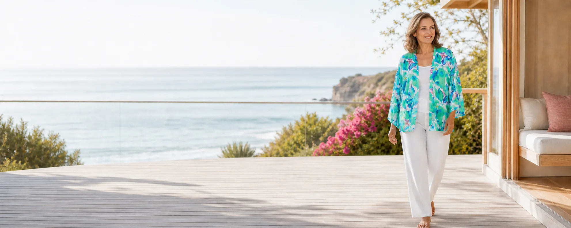 Mature model wearing the Claire Powell Broome modal kimono at a coastal resort